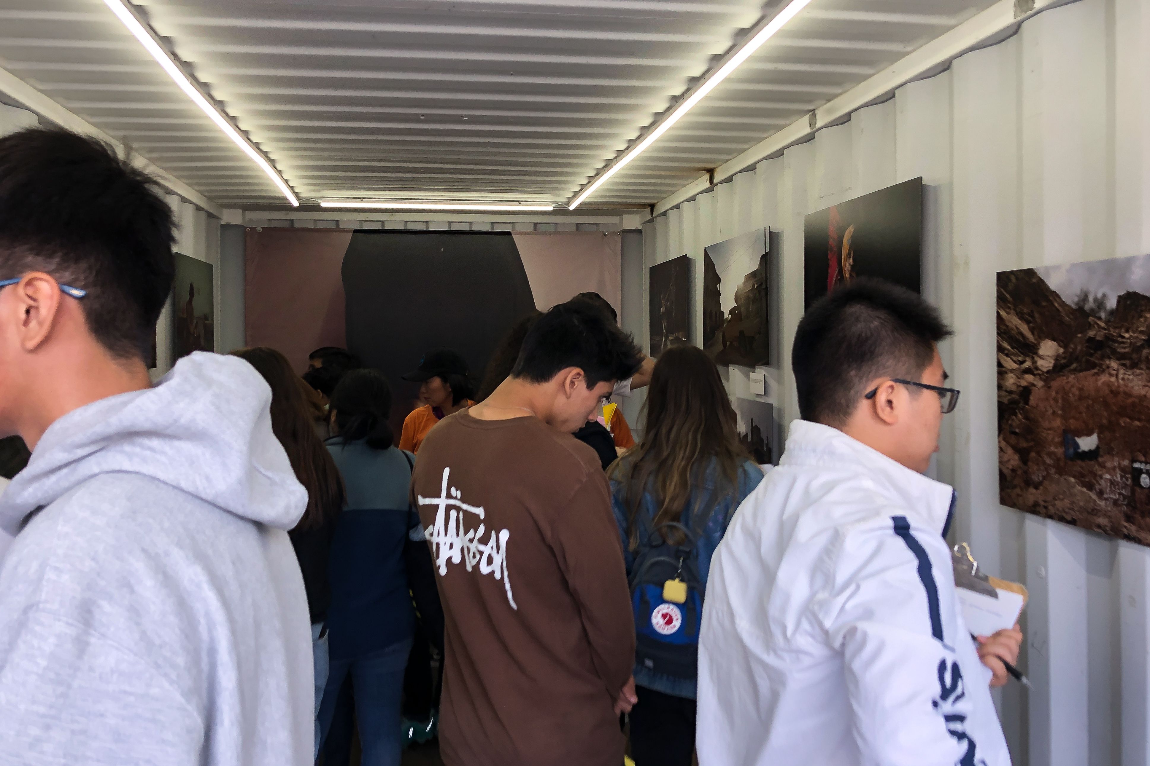 Students explore and discuss Nariman el-Mofty's photos at Photoville's Education Day. Image by Claire Seaton. United States, 2019.