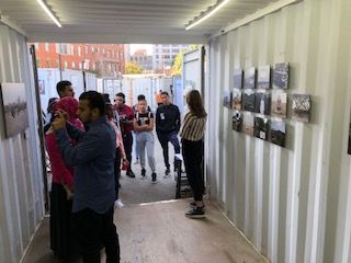 Claire Seaton discusses the exhibit with students at Photoville's Education Day. Image by Jon Sawyer. United States, 2019.