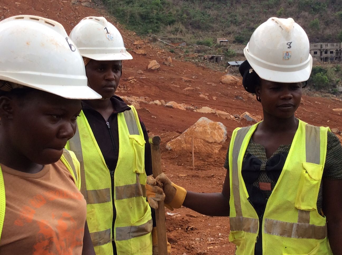 (From L to R) Jinnah Vormboi, Musu Jabbie, at Fatmata Sheriff listen to instructions from Trudy Morgan (not shown) at the Regent work site on Sugar Loaf Mountain. Image by Kadia Goba. Sierra Leone, 2018.