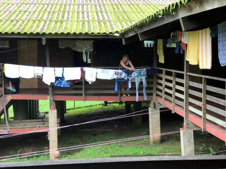 A Cuban migrant tends freshly washed clothes at the Los Planes shelter in Gualaca, in the Chiriquí province in western Panama. Image by Mario J. Pentón. Panama, 2017.