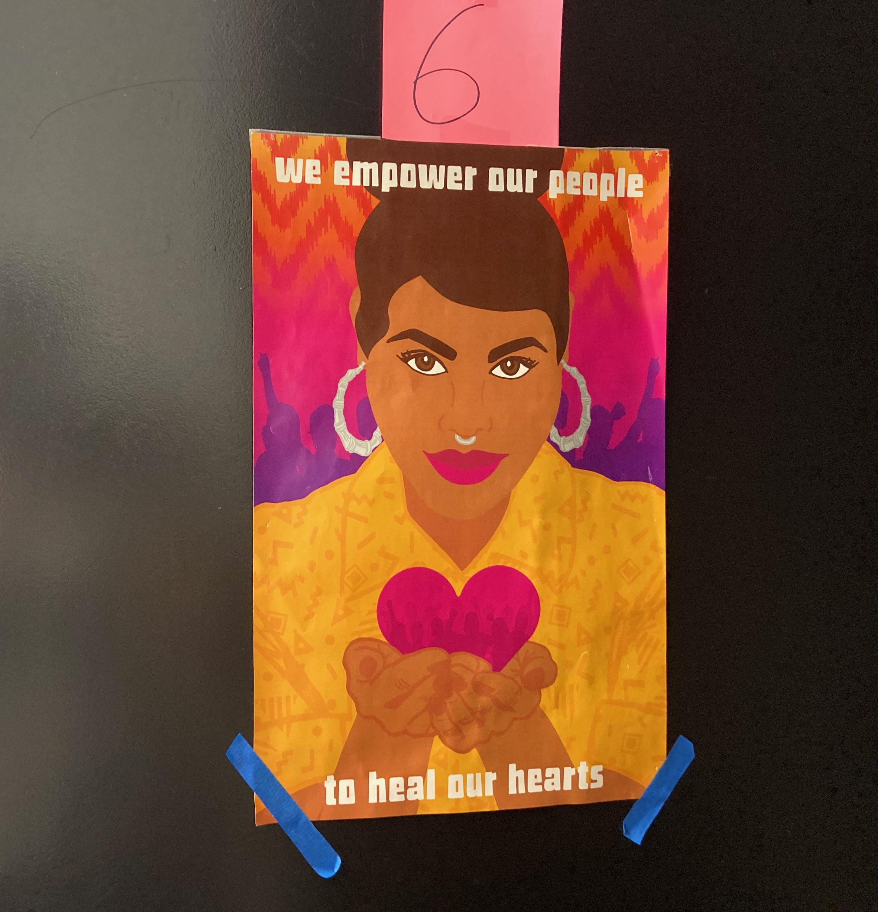 A poster hangs outside an office door at MICOP. Image by Julia Knoerr. United States, 2020.