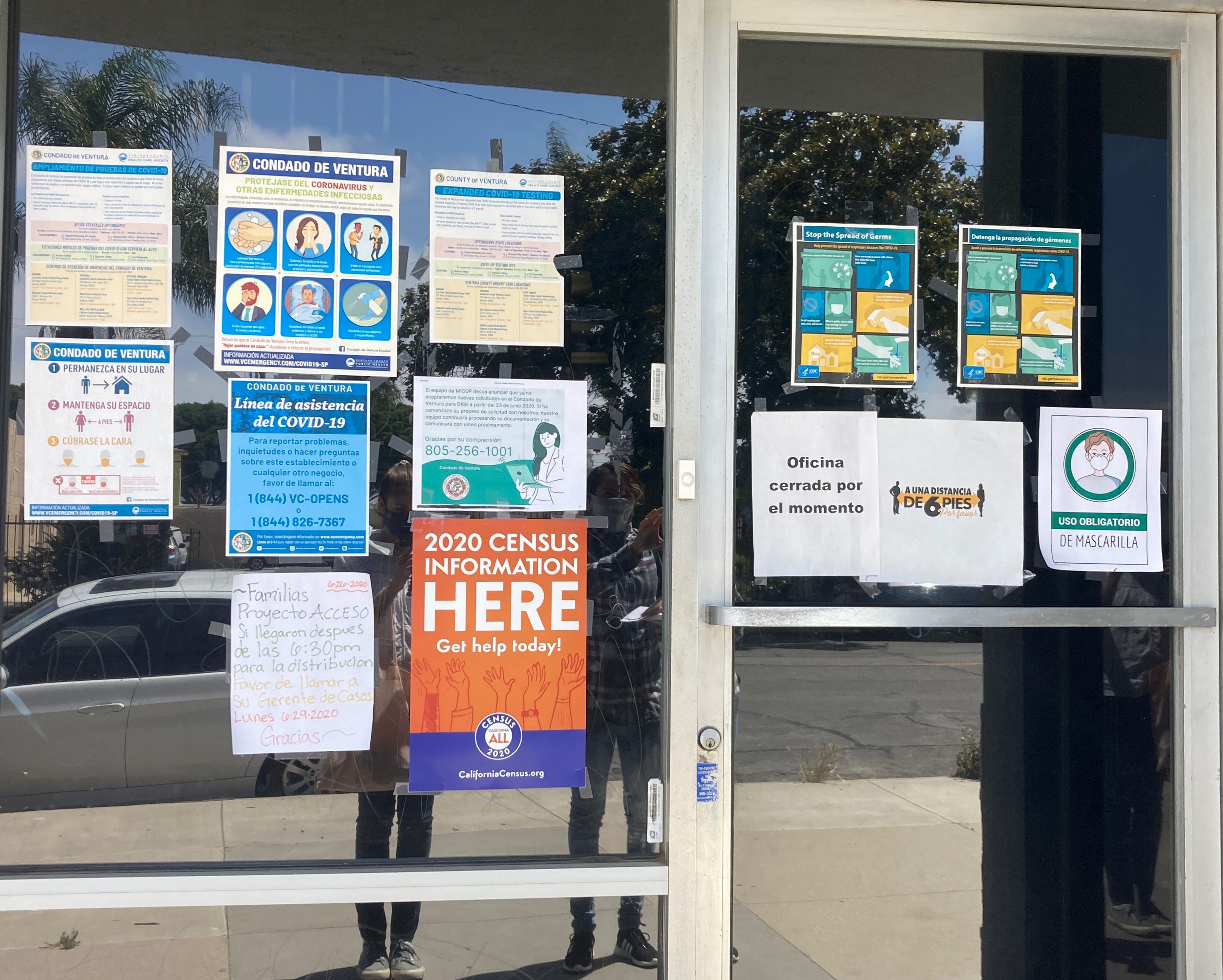 Signs direct community members to resources on MICOP's front window.
