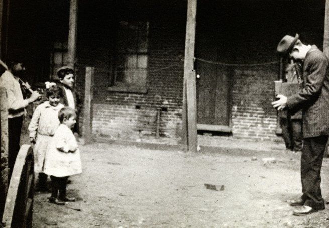 Lewis Hine photographing children in a slum c. 1910