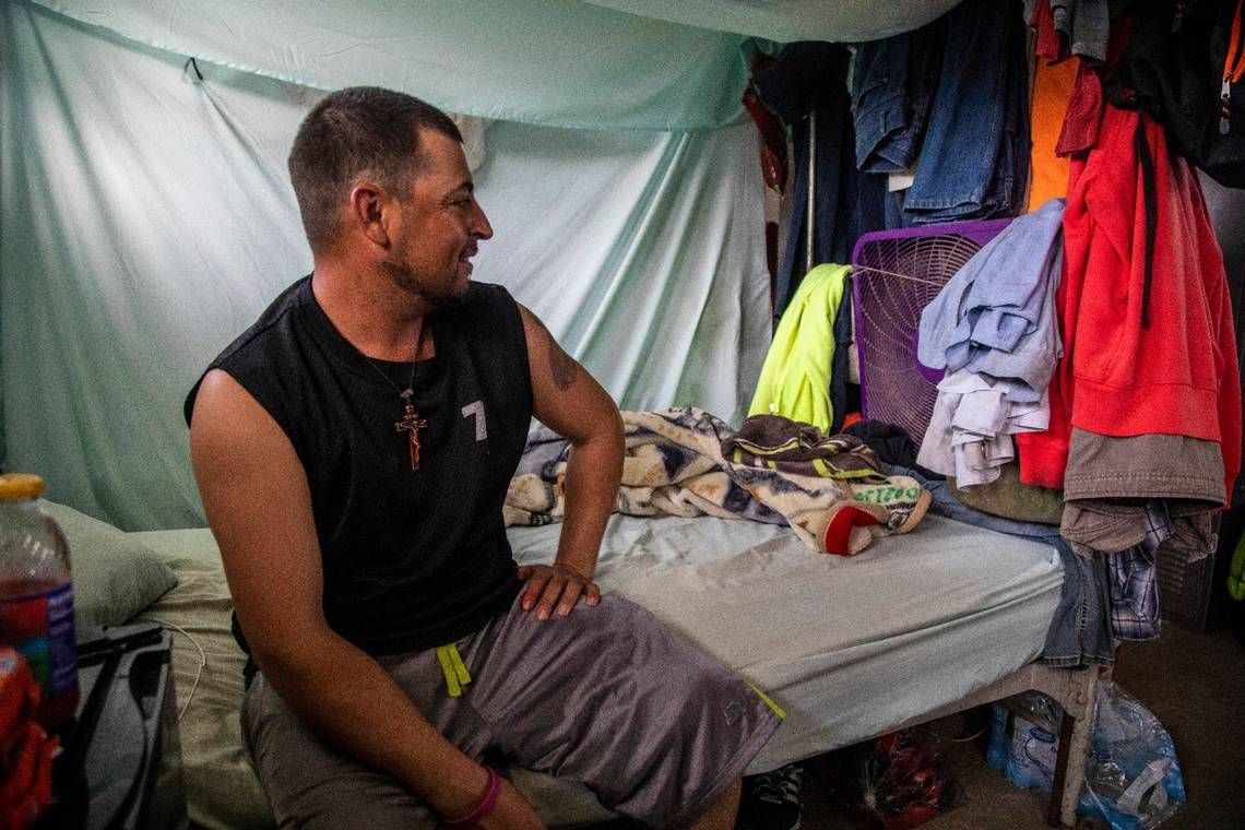 Jose, a tractor operator, sits in his living quarters at a Johnston County farmworker camp on Thursday, August 27, 2020. The camp does not have air conditioning which is considered a luxury by many farmworkers in North Carolina. Image by Travis Long. United States, 2020.