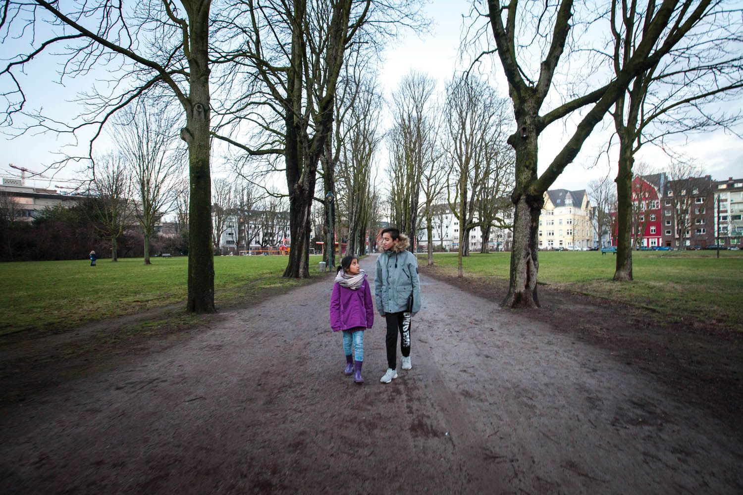 Milad (right) with his sister Mahya at the Frankenplatz park near their shelter in Düsseldorf. Image by Diana Markosian. Germany, 2017.
