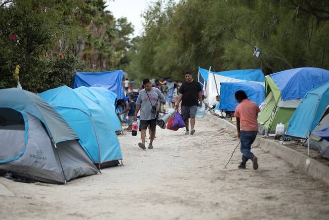 The camp near the Gateway International Bridge, which connects Matamoros and Brownsville, began forming last year. Media reports say Mexican officials plan to move the migrants to a stadium farther from the river. Image by Miguel Gutierrez Jr. Mexico, 2019.