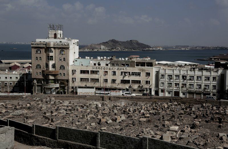 This Feb. 17, 2018, photo shows the Mercedes Benz building damaged in Aden, Yemen. Once a peg in a thriving commercial center that sprang up under colonial rule, the dealership sits empty and pockmarked with bullet holes. Its damaged sign now stands over bay windows boarded up by people sheltering inside. With the war still raging, nothing is being rebuilt. Image by Nariman El-Mofty. Yemen, 2018.

