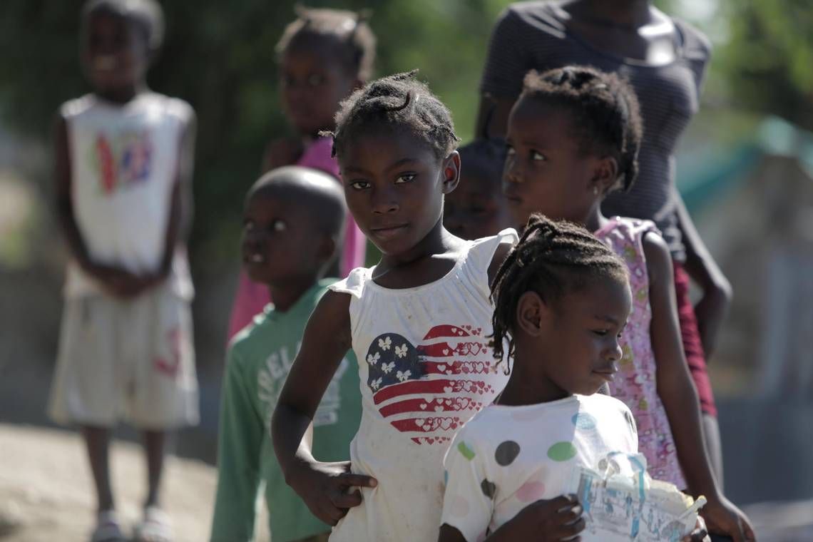A group of children checks out visitors at the Teren Toto camp in Haiti. Image by Jose A. Iglesias. Haiti, 2019.