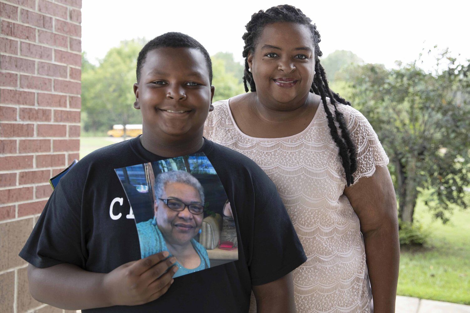 Karlton Jackson (left), age 10, holds a photo of his late grandmother, Carol Faye Doby, as he stands with his mother Shenika Jackson (right) on Friday, September 25, 2020 in Bolton, MS. Doby, of Stonewall, passed away from complications of COVID-19 earlier this year. Image by Sarah Warnock/MCIR. United States, 2020.

