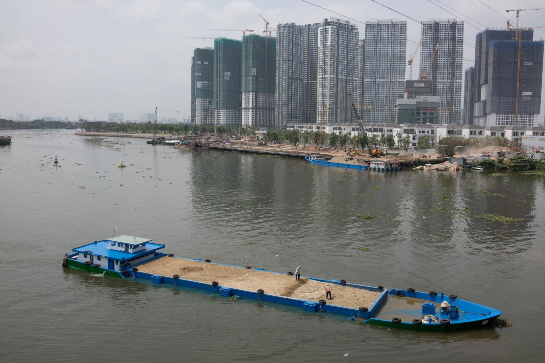 Ho Chi Minh City, formerly known as Saigon, is Vietnam's economic center. Much of the sand being dredged and pumped up from the Mekong goes towards construction here and in other cities in southern Vietnam. But some has been exported to Singapore, which requires large amounts of sand for land reclamation projects. Image by Sim Chi Yin. Vietnam, 2017.

