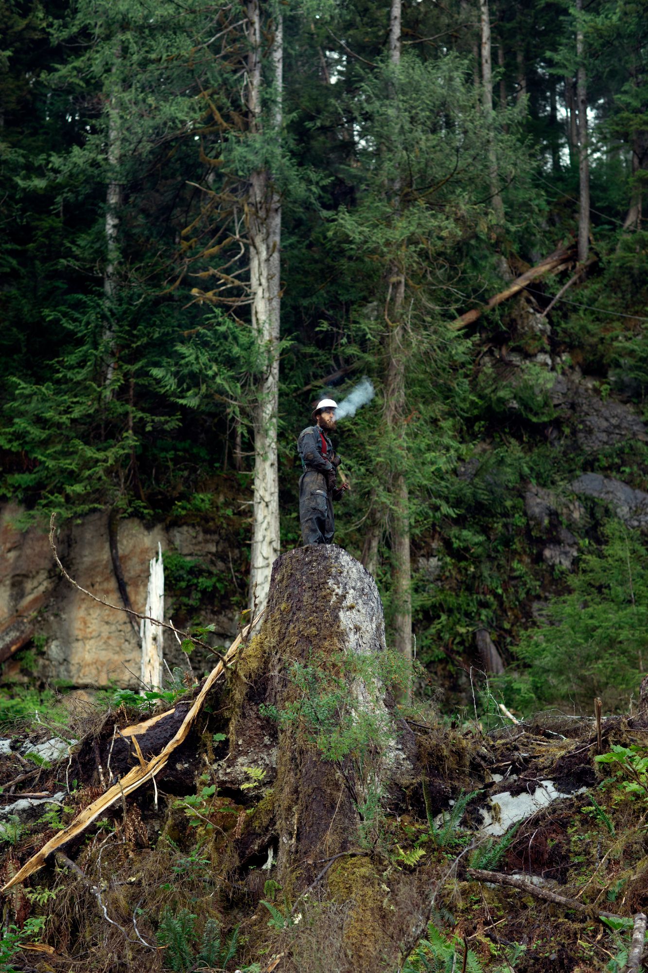 Drew Newman, wearing red suspenders, prepares at the Tuxekan logging site. Image by Joshua Cogan. United States, 2019.