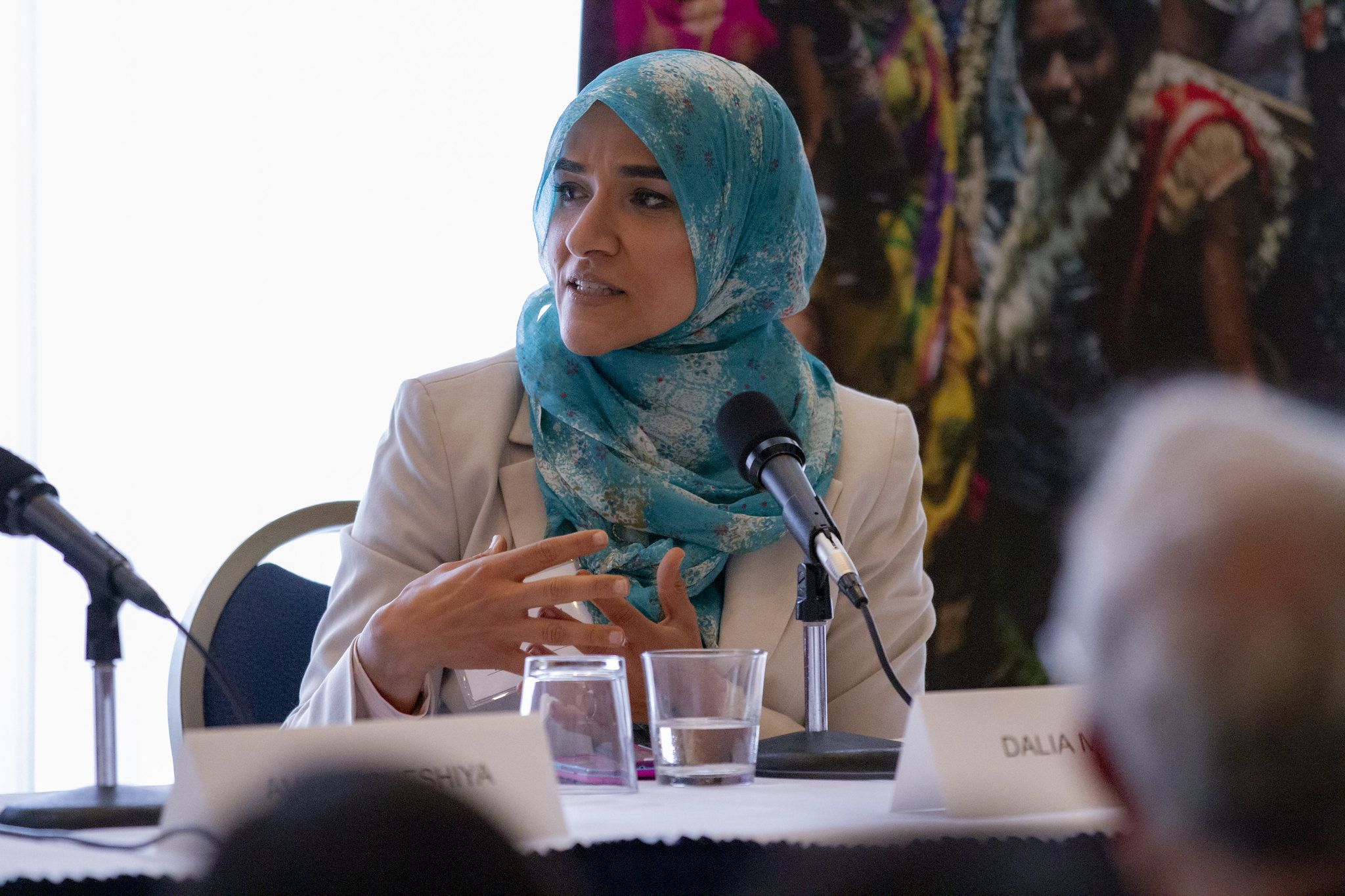 Dalia Mogahed addresses an audience member at the “Beyond Religion” conference. Image by Jin Ding. Washington, D.C., 2019.