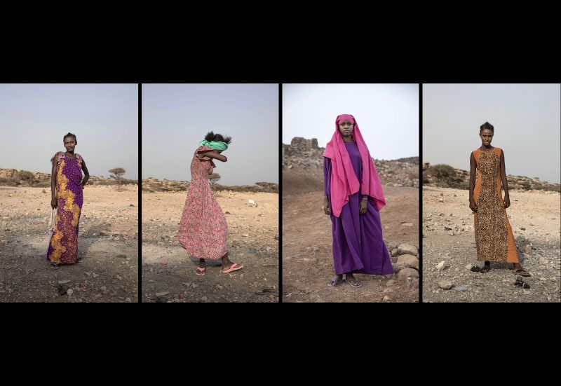 From left, Ethiopian migrants Medres, 15; Willo, 15, laughing; Ikram Abdi, 17; and Hades, 16, pose for portraits in Obock, Djibouti, mid-July 2019, at the last stop of their journey before leaving in the evening by smugglers' boat for the eight-hour trip to Yemen. Image by AP Photo / Nariman El-Mofty. Djibouti, 2019.