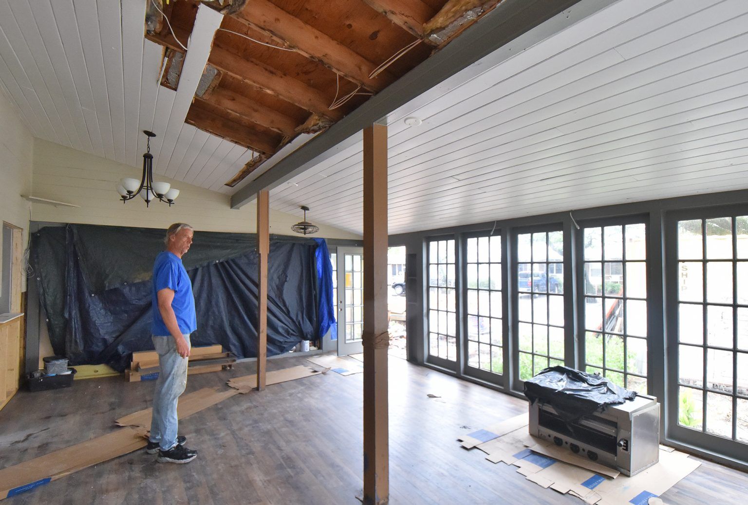 Doug Eifert, co-owner of Dajio on Ocracoke Island is shown last week in the restaurant’s main dining room, which is still under repair from damage sustained during Hurricane Dorian. Image by Dylan Ray. United States, 2020.