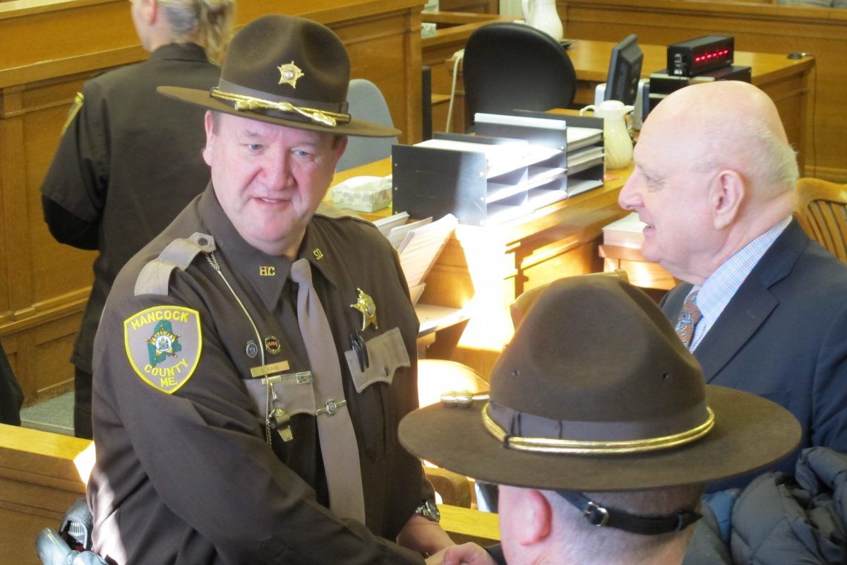 Hancock County Sheriff Scott Kane shakes hands with well-wishers after being sworn into office on Jan. 1, 2015. Image by Bill Trotter / Bangor Daily News. United States, 2015.