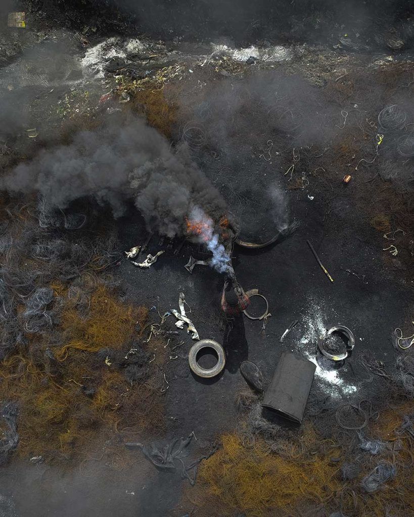 An aerial view of a site in Onitsha where copper wire, trash, and slaughterhouse waste is burned. Image by Larry C. Price. Nigeria, 2018.