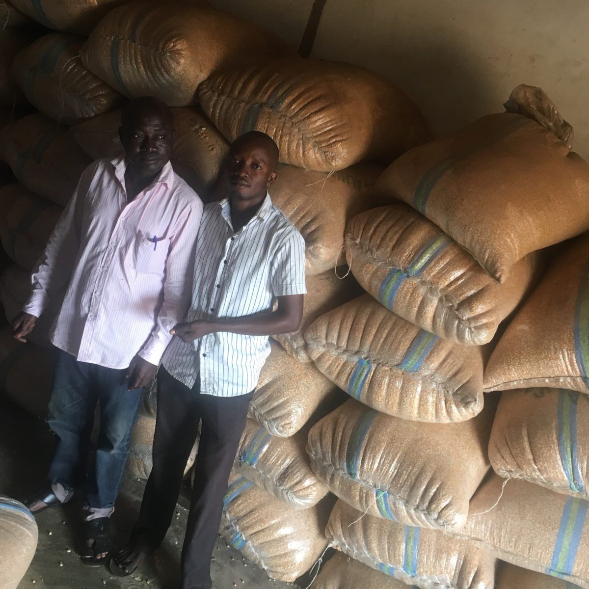 Grain merchant Kabiru Sanusi and his son Habeeb Babatunde at Elekaara Market in Ibadan, Nigeria. Image by Wome Uyeye. Nigeria, 2018.