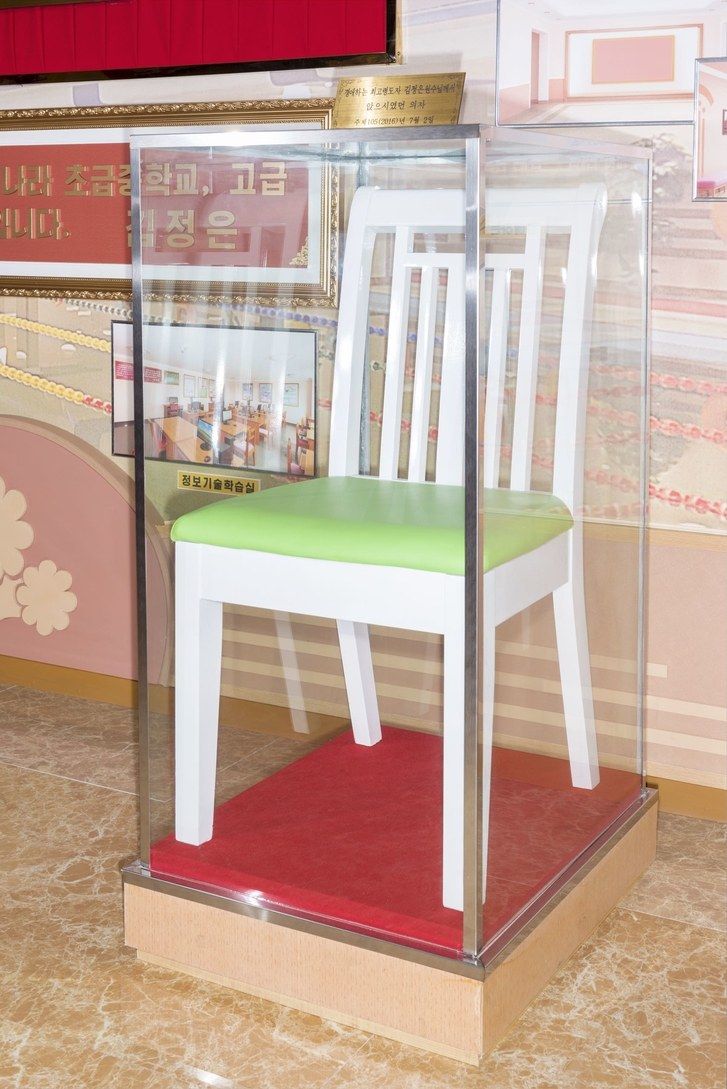 A chair used by Kim Jong Un during his visit to the Pyongyang Orphans’ Secondary School, in a room dedicated to commemorating his visit. Image by Max Pinckers/The New Yorker. North Korea, 2017.