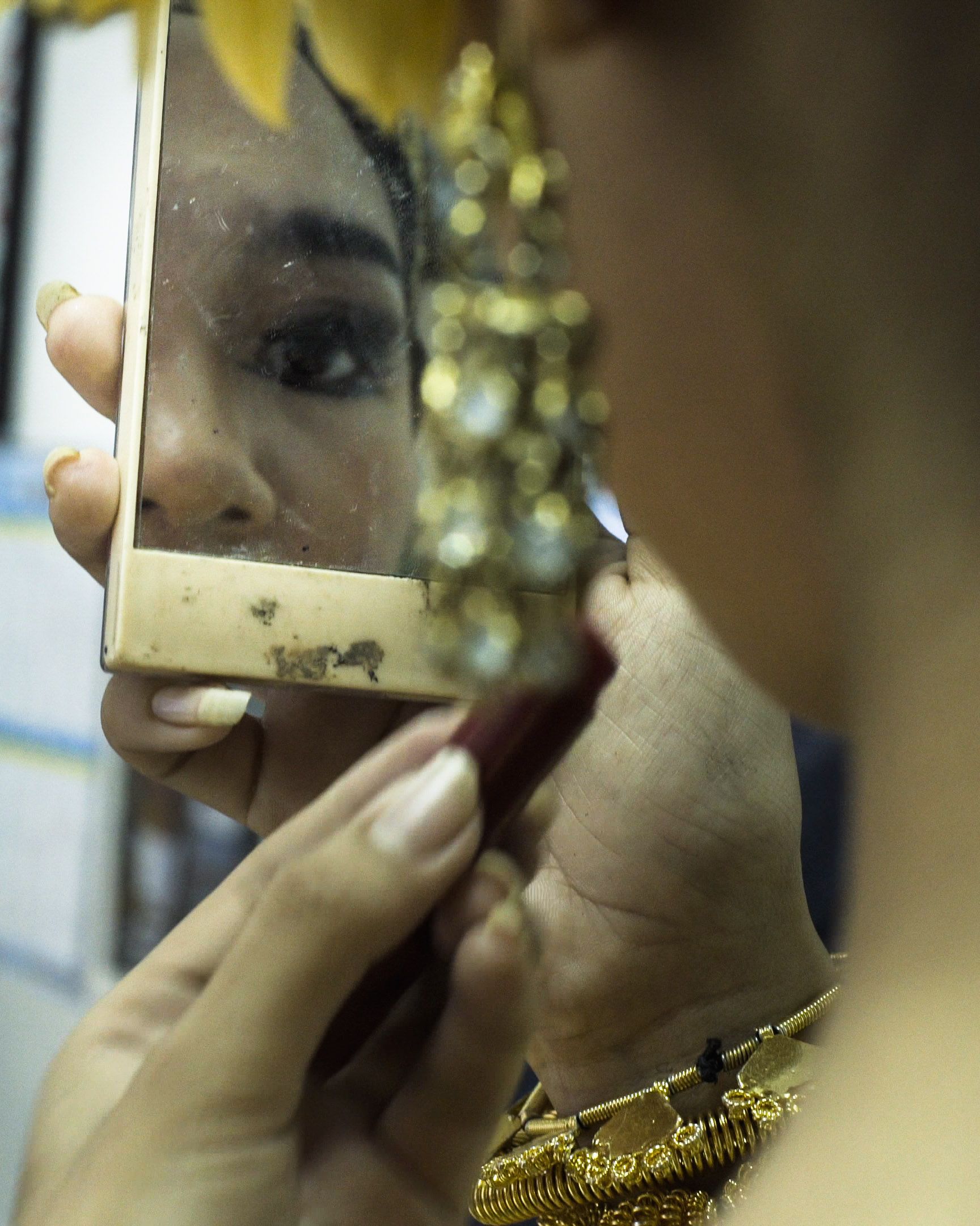 Saly Sreymeas applying lipstick. Image by Ingrid Olivia Norrmén-Smith. Cambodia, 2019.