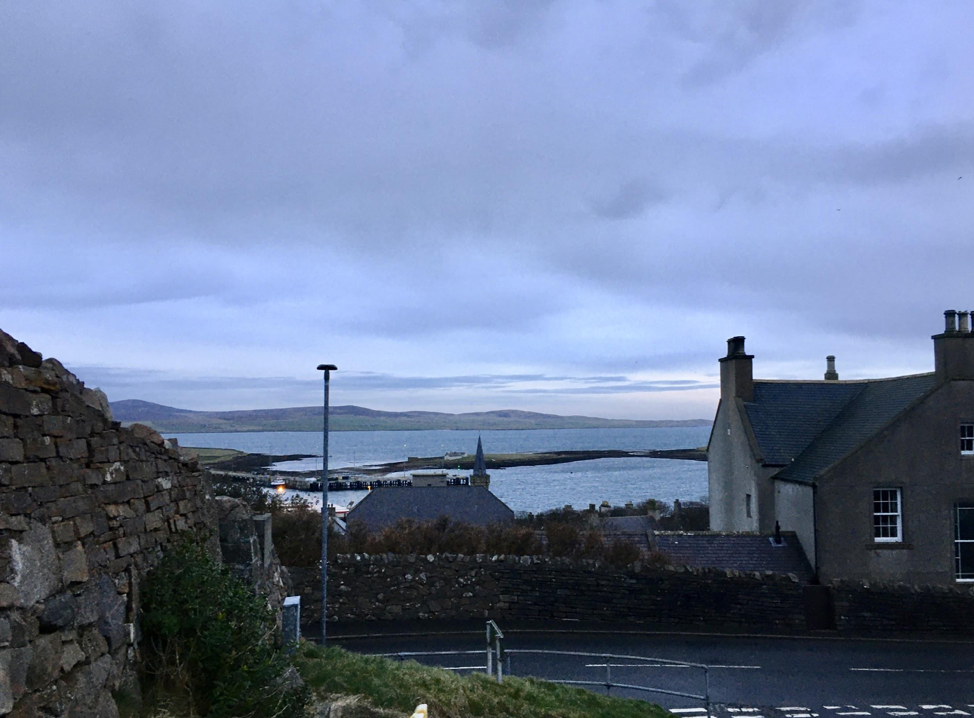 A view of the water and the other end of the Orkney mainland from the top of a hill in Stromness. Image by Maggie More. United Kingdom, 2020.
