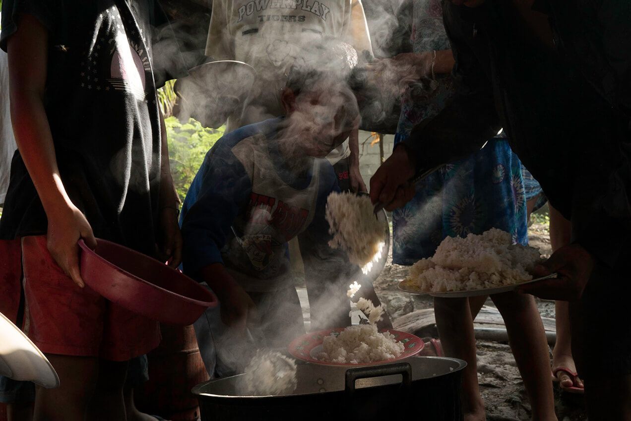 Assigned cooks must prepare enough rice and vegetables to feed the 70-some survivors staying in Koronadal City. Image by Chien-Chi Chang/Magnum Photos. Philippines, 2018.