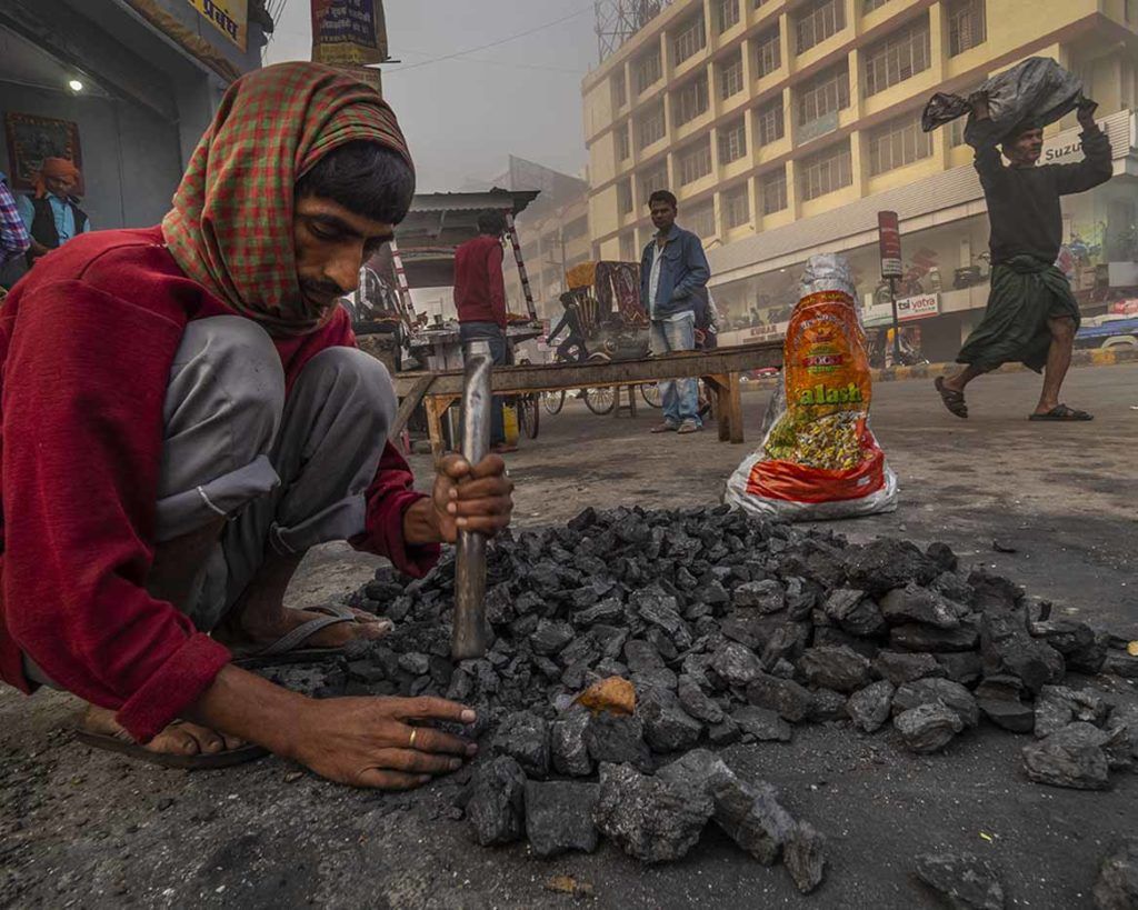 Each morning in Patna, tens of thousands of small coal fires are lit across the city. Coal burning is a major contributor to PM 2.5 pollution in Patna and such small-scale fires, used for heating and cooking, release toxic gases both inside homes and on the streets. Image by Larry C. Price. India, 2018.