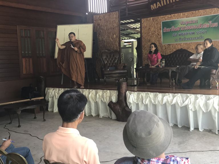 Phrakhu Sangkom Thanapanyo Khunsuri gives a speech to the villagers of Surin on the importance of trees and stopping deforestation. Image by Kiley Price. Thailand, 2018.