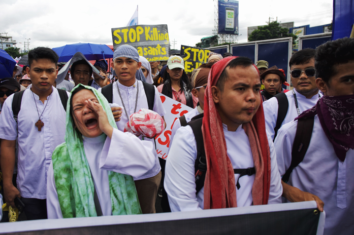 Members of Rise Up for Life and for Rights, which is composed of various religious groups and human rights advocates, rally against the drug-related killings hours before President Rodrigo Duterte’s state of the nation address. Image by Pat Nabong. Philippines, 2017.