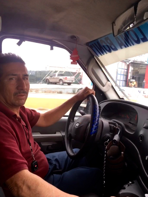 José Luís Cisneros Dávila at the wheel of his taxi de ruta, a converted ambulance. Image by Patrick Reilly. Mexico, 2017.
