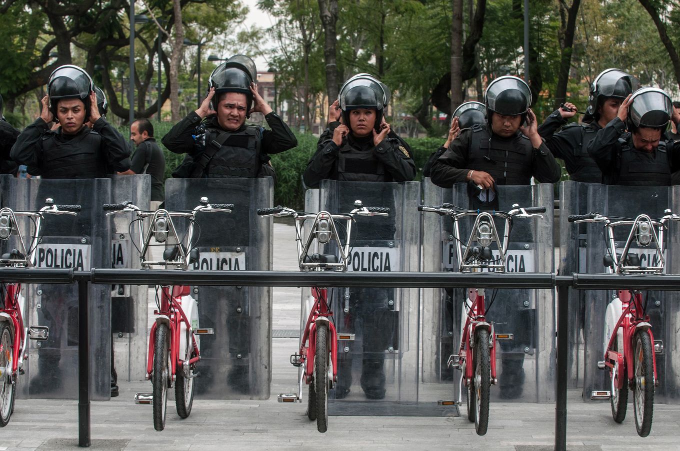 Riot police assemble behind a bikeshare station, in 2013, preparing to confront a march organized by teachers unions opposed to Peña Nieto’s educational reforms. Image by Eneas De Troya. Mexico, 2013.