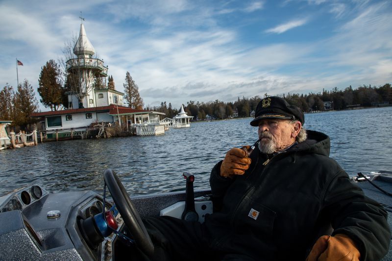 Kenneth "Captain Ken" Kloster Sr. pilots his boat to his home on Dollar Island in Les Cheneaux Islands on Lake Huron in the Upper Peninsula of Michigan on Nov. 23, 2019. He bought the island in 1981 right before record setting high water levels of 1986. Image by Zbigniew Bzdak / Chicago Tribune. United States, 2020.