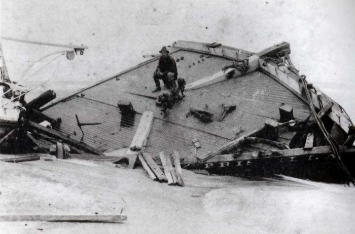 Rasmus Midgett sits on the wreckage of Priscilla in 1899. Image courtesy of NC Division of Archives and History. United States, 1899.