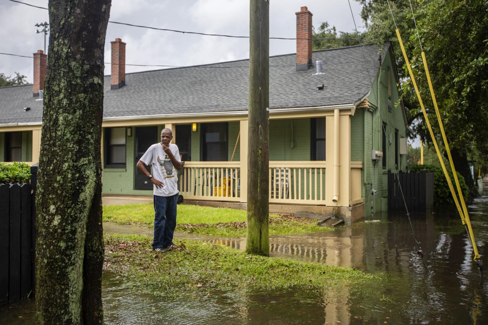Derwin Wise looks down President Street from Gadsden Green as water floods the road Friday Sept. 25, 2020, in Charleston. Image by Gavin McIntyre/Post and Courier Staff. United States, 2020.