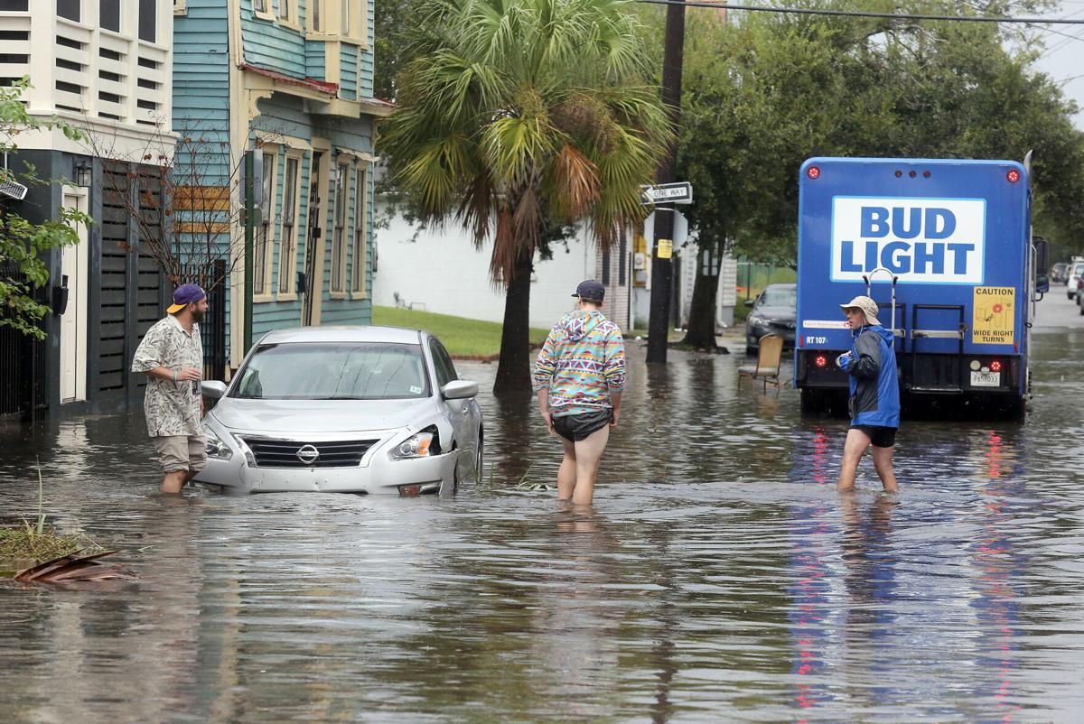 After the rain subsided Friday, Sept. 25, 2020, residents on America Street in Charleston’s East Side check the flooding. In two hours, more than 3 inches of rain fell on the Charleston peninsula, flooding streets all over downtown. Image by Brad Nettles/Post and Courier Staff. United States, 2020.