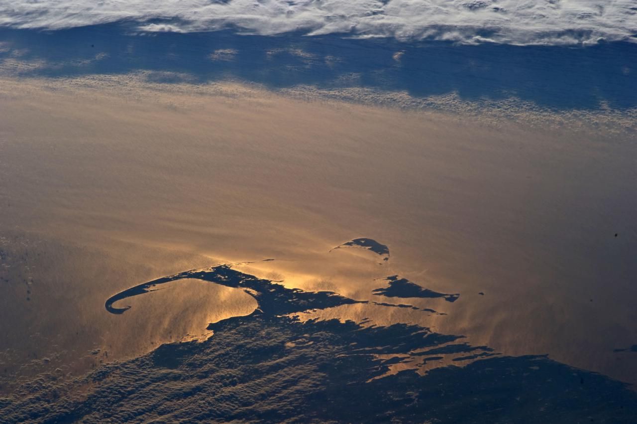 Sunset over Cape Cod, photographed by NASA astronauts aboard the International Space Station. Image courtesy of Earth Science and Remote Sensing Unit, NASA Johnson Space Center. United States, 2019.