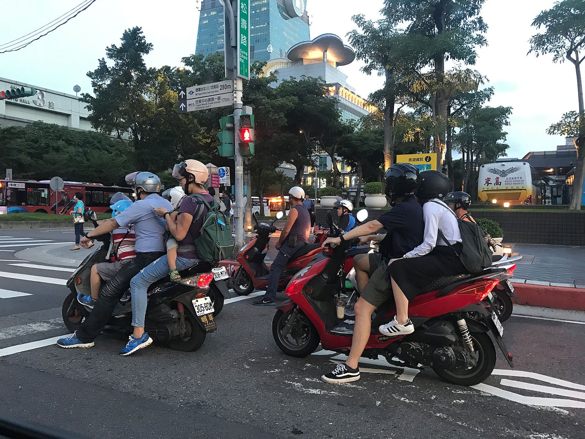 Taiwanese commuters often rely on scooters, sometimes crowding a whole family onto one of these vehicles. Image by Melissa McCart. Taiwan, 2018. 