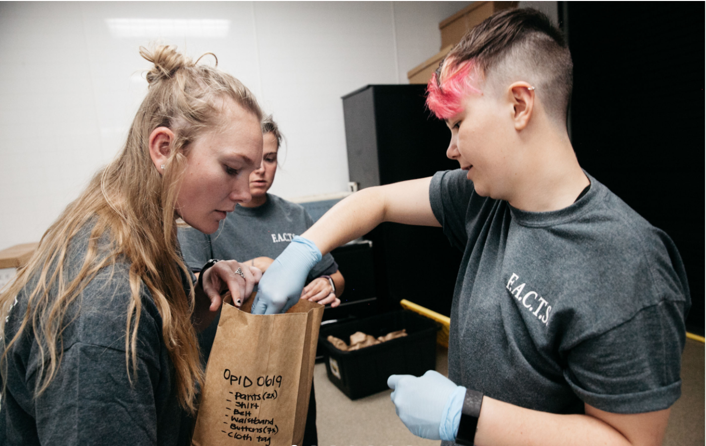 Anthropology seniors Cari Helgeson and Shelly White store migrant remains at the Forensic Anthropology Center at Texas State University in San Marcos. The team goes through a rigorous documentation and organization process to catalog, clean  and store the items by case numbers. Image by Julysa Sosa. United States, 2017.