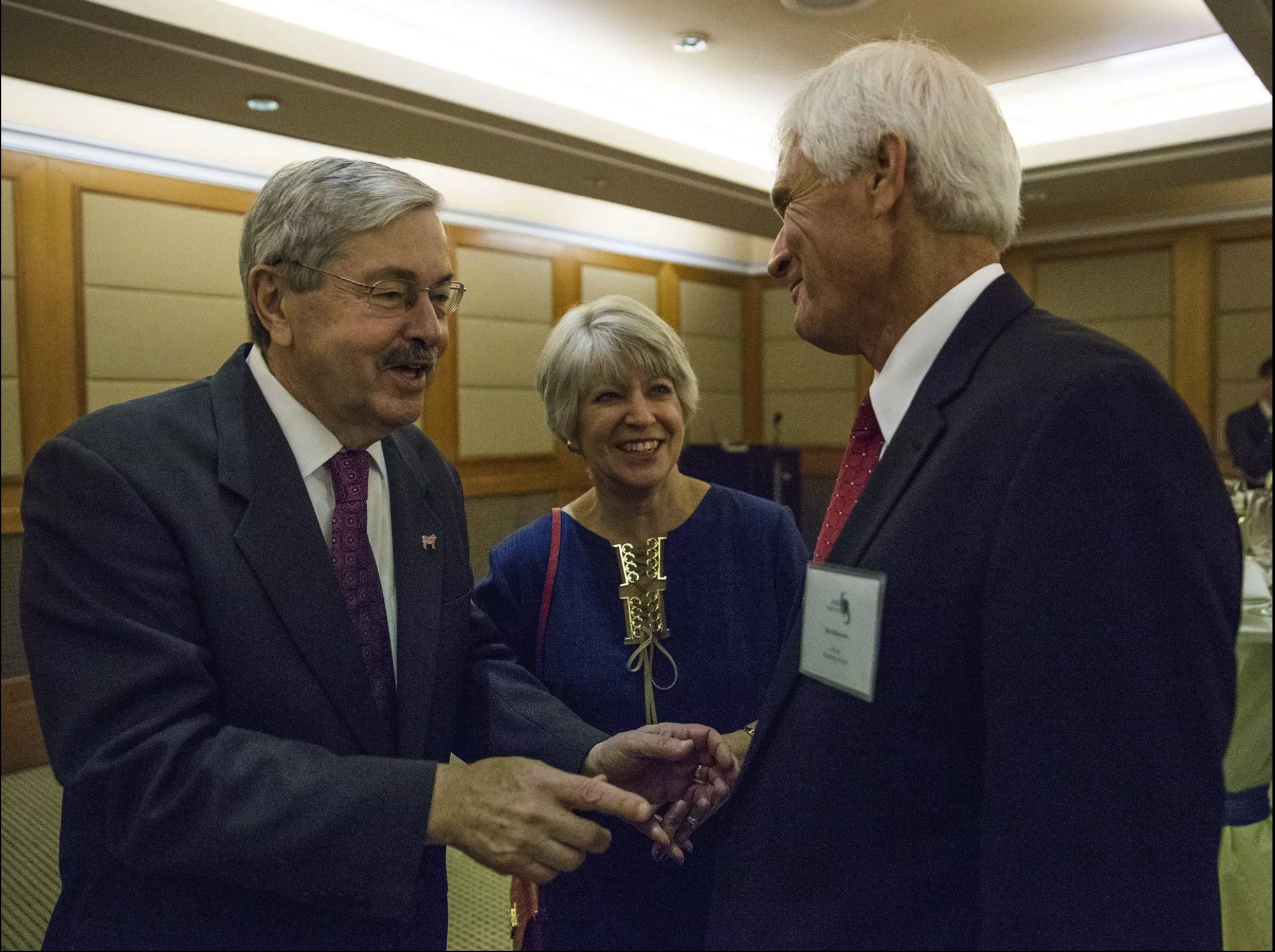 Terry Branstad, U.S. ambassador to China, and his wife, Chris Branstad say hello to Rick Kimberley, a corn and soy bean farmer from Iowa, during an Iowa Sister States reception on Wednesday, Sept. 20, 2017, in Beijing, China. A groundbreaking will be held this weekend for a replica of Kimberley's family farm being built in China. Image by Kelsey Kremer. China, 2017.