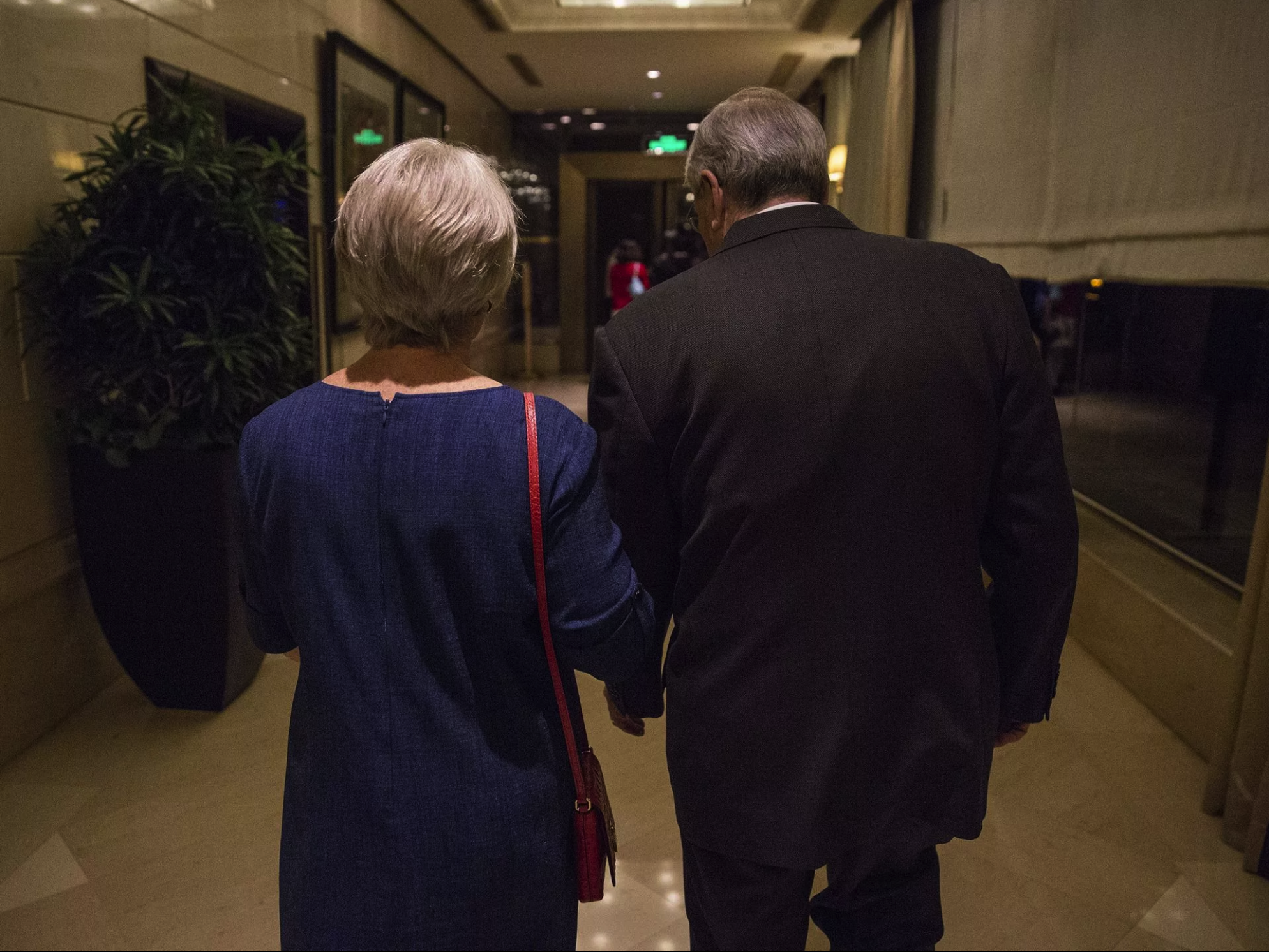 Terry Branstad, U.S. ambassador to China and his wife Chris Branstad leave the St. Regis hotel after an Iowa Sister States reception on Wednesday, Sept. 20, 2017, in Beijing, China. They walked home to their embassy residence, only a few blocks away, after the reception. Image by Kelsey Kremer. China, 2017.