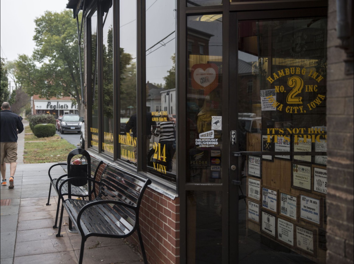 Two customers walk down the sidewalk after eating at the Hamburg Inn No. 2 on Friday, Oct. 6, 2017, in Iowa City. Image by Kelsey Kremer. United States, 2017.
