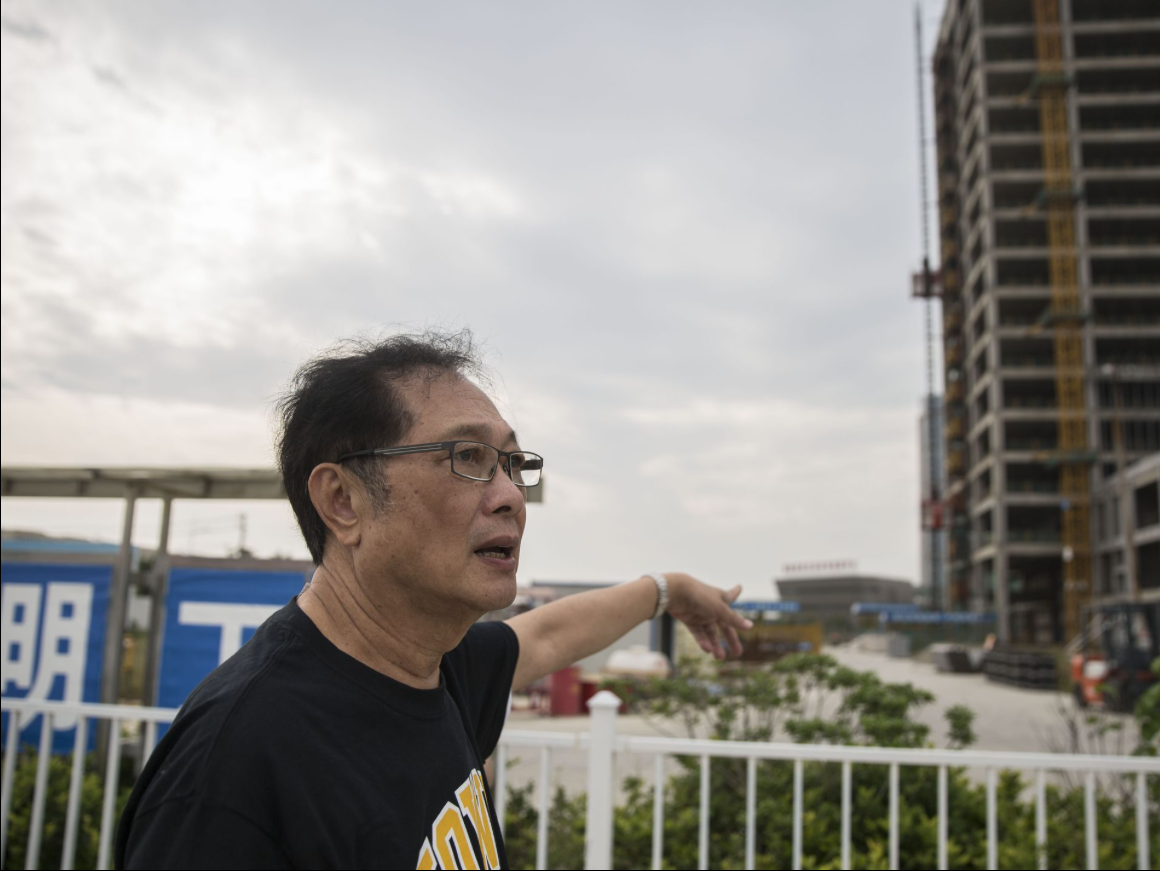 Michael Lee, owner of the Hamburg Inn No. 2 in Iowa City, points to the construction of the future home of his business in China, including the expansion of restaurants, on Friday, Sept. 29, 2017, on Taizhou, China. Image by Kelsey Kremer. China, 2017.