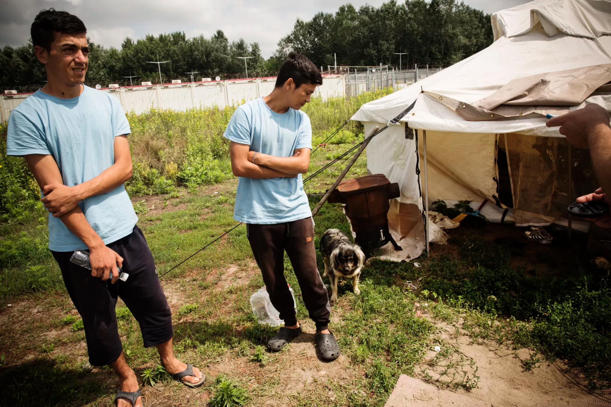Hashmat (L) and Faiz outside their living quarters in June. Image by Zack Beauchamp for Vox. Hungary, 2018.