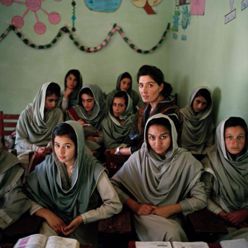 Nadia Khan, a 23-year-old Ismaili teacher, sits among her students. Ismailis are known in Pakistan for supporting female education, but they have limited influence outside of the Hunza valley in Gilgit-Baltistan. The only girls’ school in Minawar village, with 24 students between the ages of 14 and 17, still struggles to keep girls in school instead of leaving for marriage at age 15. “It’s a challenge for me,” says Principal Bibi Raj. “All girls should go to school.” Image by Sara Hylton/National Geographic. Pakistan, 2019.