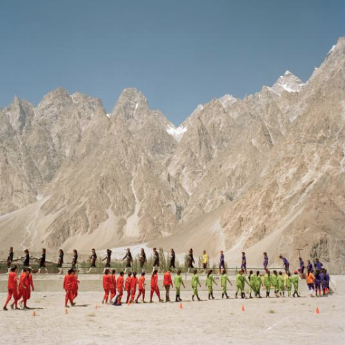 All-girl teams from surrounding villages walk onto the field during the soccer tournament. Image by Sara Hylton/National Geographic. Pakistan, 2019.