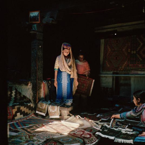 Women of Pakistan’s Wakhi minority make and sell traditional hand-woven carpets in Gulmit village in the Hunza valley. Image by Sara Hylton/National Geographic. Pakistan, 2019.