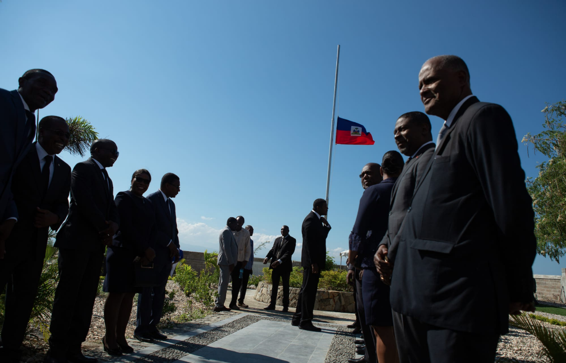 A flag flies half staff as dignitaries gather for a wreath-laying ceremony at the St. Christophe memorial just north of Port-au-Prince. Image by Allison Shelley. Haiti, 2019.