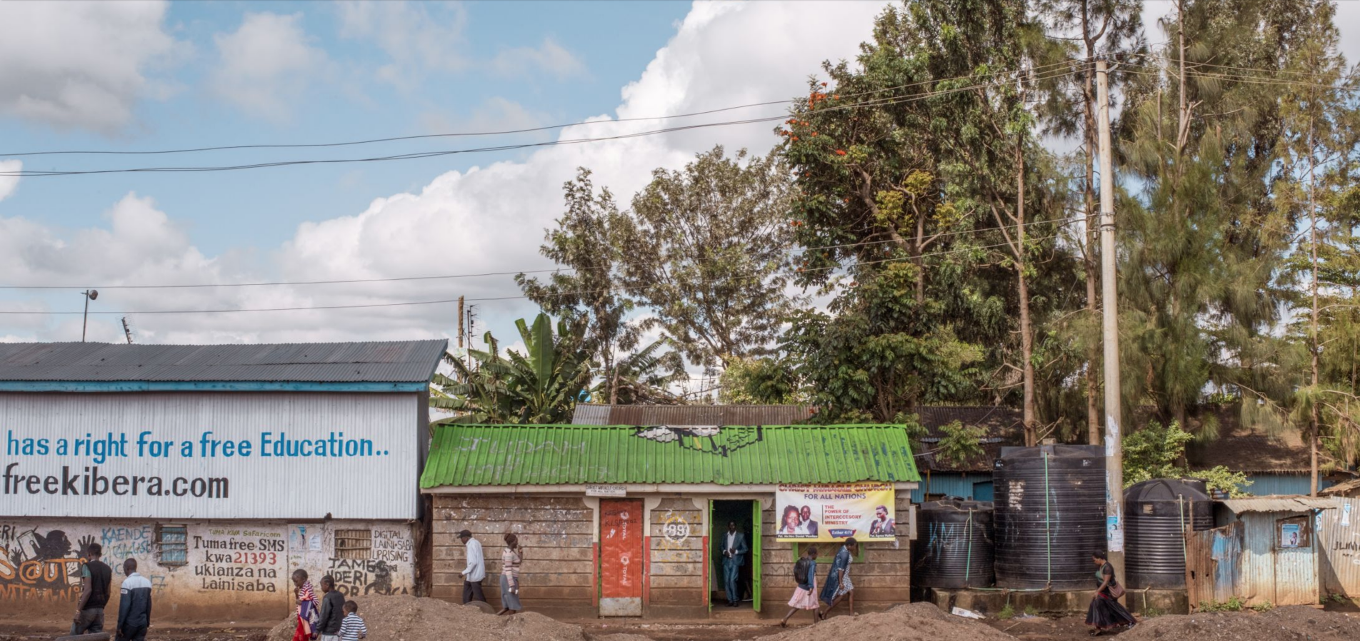 Christ Miracle Church, center, originally built as a public toilet, in Kibera, Nairobi. Image by Peter DiCampo. Kenya, 2018.