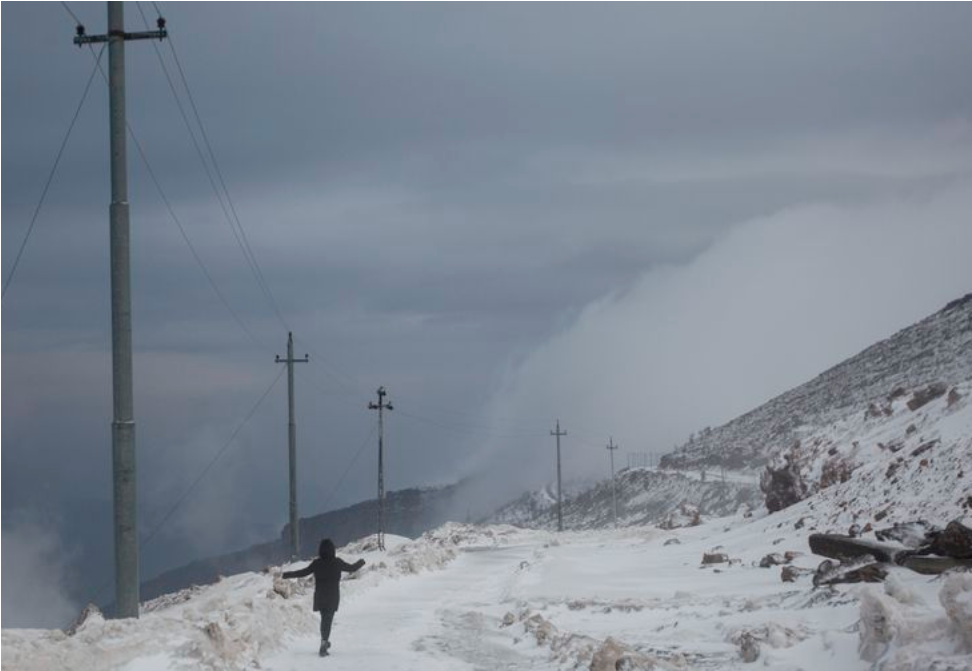 Zahra Ahmad skips down a trail from Mount Korek in Iraqi-Kurdistan on Friday, Feb. 8, 2019. The mountain is an international destination for many travelers and is only accessible by cable car. Image by Brontë Wittpenn. Iraq, 2019.