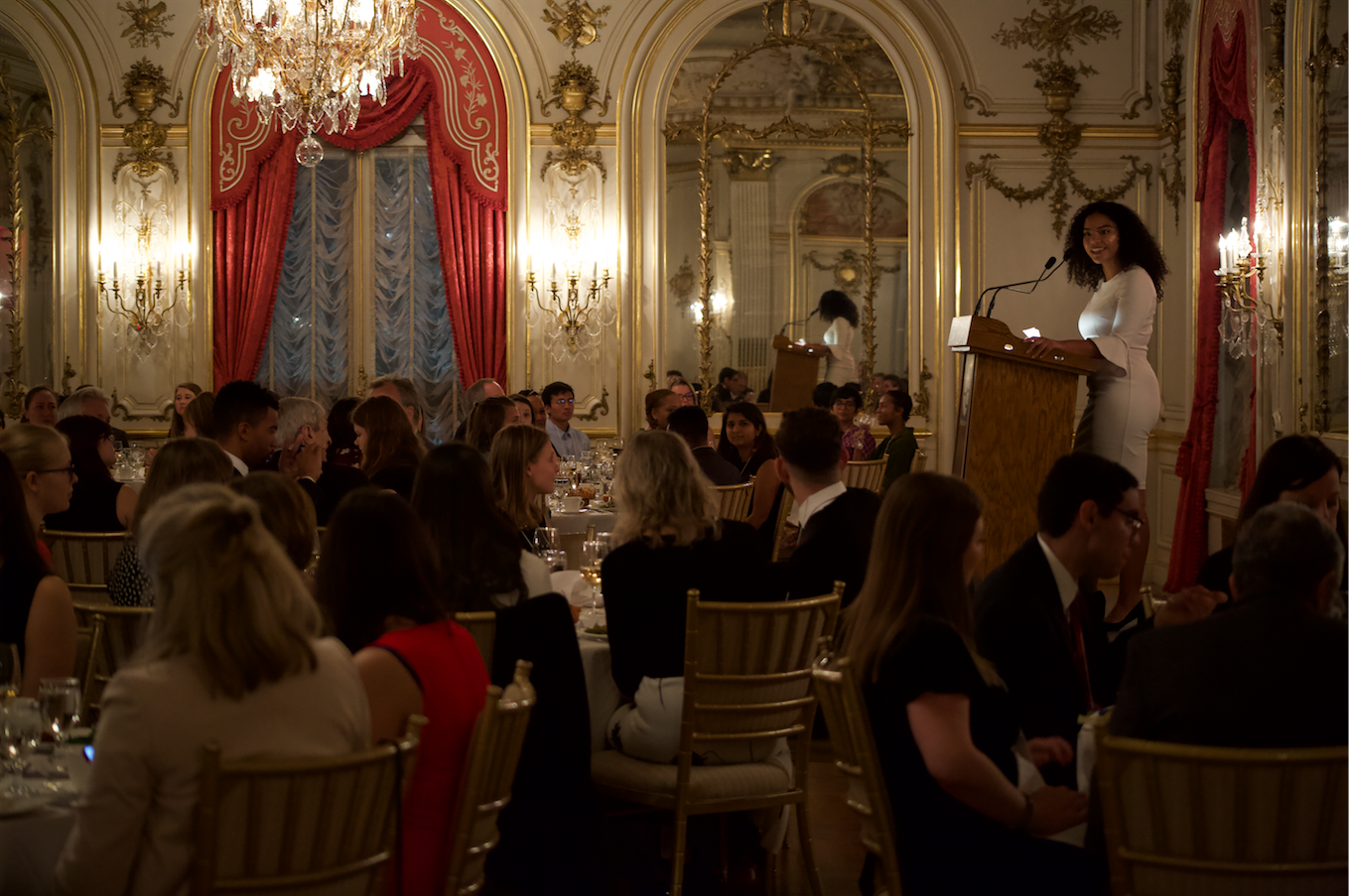 Camila DeChalus, former Pulitzer Center reporting fellow from American University and a current grantee who works as a reporter for CQ Roll Call covering homeland security and immigration, addressed guests during the Cosmos Club dinner. Image by Claire Seaton. United States, 2019. 