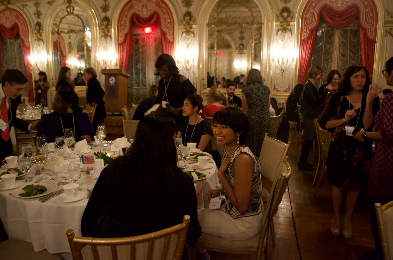 Isabella Gomes (Johns Hopkins School of Public Health) laughing at the Cosmos Club dinner. Image by Nora Moraga-Lewy. United States, 2019.